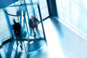 An interior shot of a revolving door in motion.