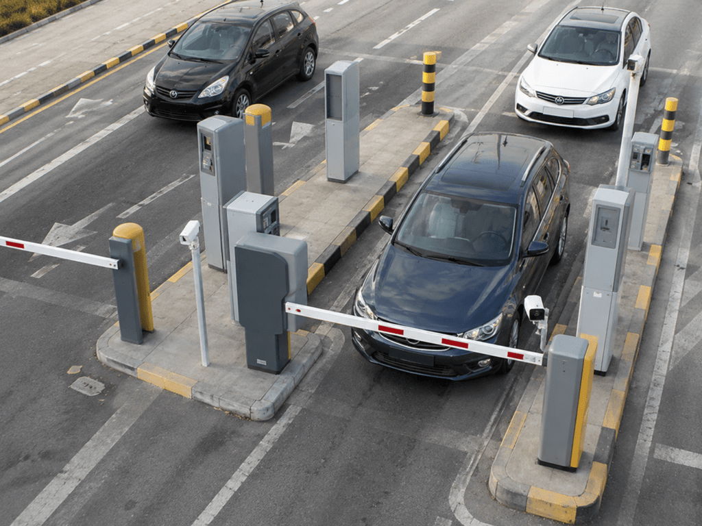 Parking management system with automatic barrier gates, access control terminals, and vehicles at a controlled entry and exit point.